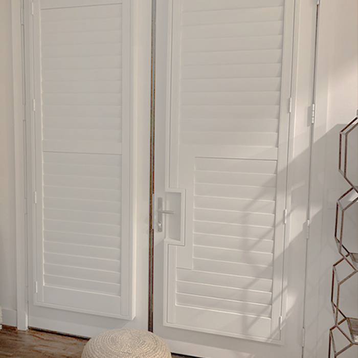 Three different French doors with white shutters.
