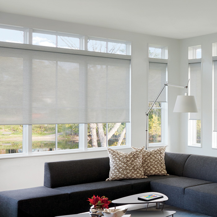 White roller shades in a modern living room.