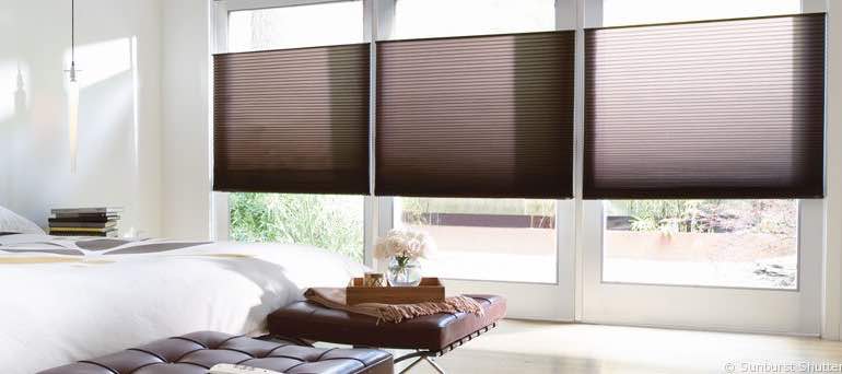 Minimal Salt Lake City bedroom with high windows and vertical honeycomb shades.