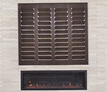 Ovation shutters above a modern fireplace