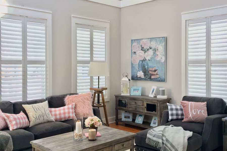 Don't like the look of traditional tilt rods? Hidden tilt rods give your shutters a tidier look. White Polywood shutters with hidden tilt rods on windows in a living room