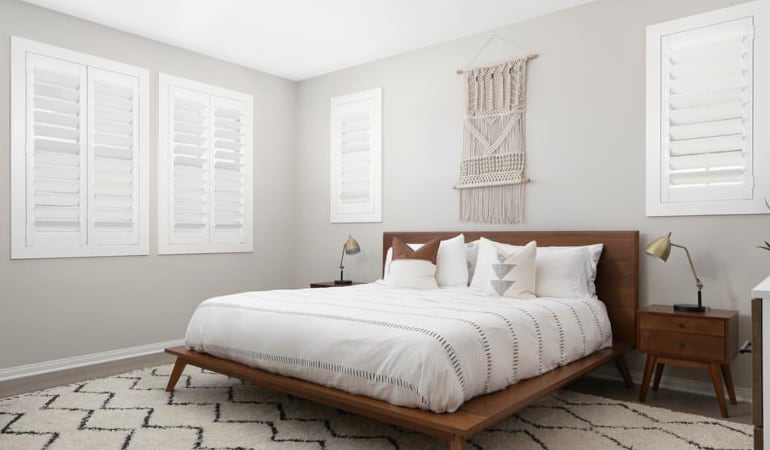 Open shutter louvers will help any Salt Lake City room feel larger. Plantation shutters in a model home bedroom.