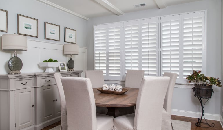 Plantation shutters are a perfect choice for homeowners looking for privacy or natural light.  Plantation shutters in a Salt Lake City dining room.