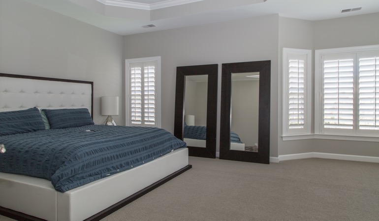 Polywood plantation shutters work well with minimalist design. Polywood shutters in a minimalist bedroom in Salt Lake City.