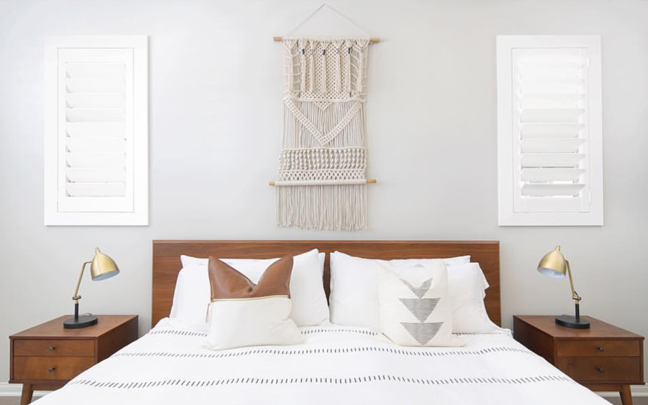 Custom-fitted louvered shutters provide excellent nighttime privacy in Salt Lake City. Photo Credit: Audrey Crisp Louvered shutters in a bedroom.