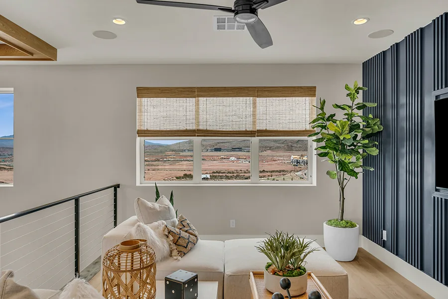 Salt Lake City homeowners who want eco-friendly home fixtures should consider natural woven shades. Natural brown woven shades on a window in a stylish sitting area