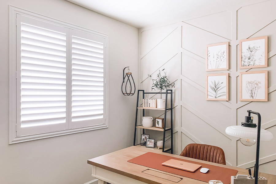 Polywood shutters give you maximum control over natural light in your Salt Lake City home. Photo Credit: @OurLakepoint Farmhouse White and off-white farmhouse style office with natural light from polywood shutters.