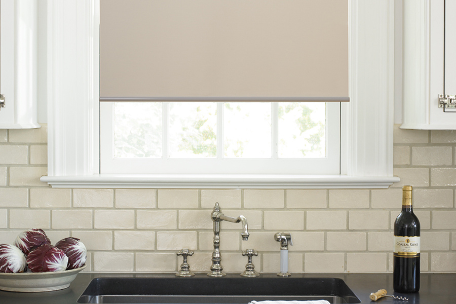 Roller shades opens up a lot of color and style options for your gourmet kitchen at Salt Lake City. Roller shade above a kitchen sink.