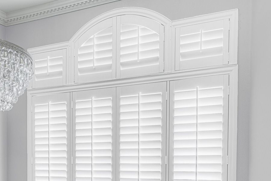 Customize your Palladian windows with white Polywood shutters in Salt Lake City. White Polywood Palladian windows in a dining room.