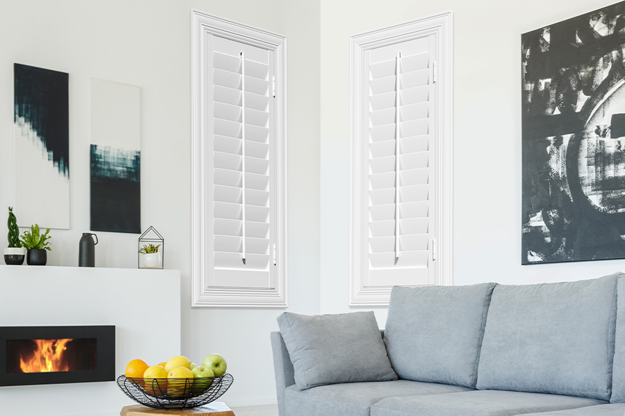 White Polywood shutters add character and class in Salt Lake City. White polywood shutters in a corner of a modern living room.
