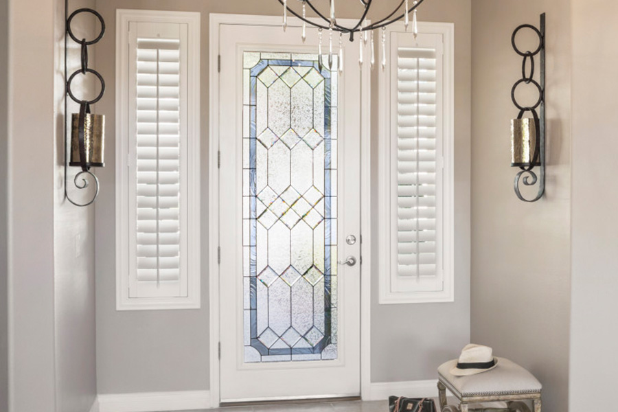 Polywood shutters offer flexibility on the brightness of natural light in Salt Lake City. Sidelight windows with white polywood shutters in a foyer.