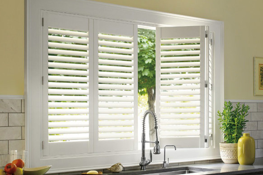 Polywood shutters are built to withstand the test of time in Salt Lake City. White Polywood shutters above a kitchen sink.