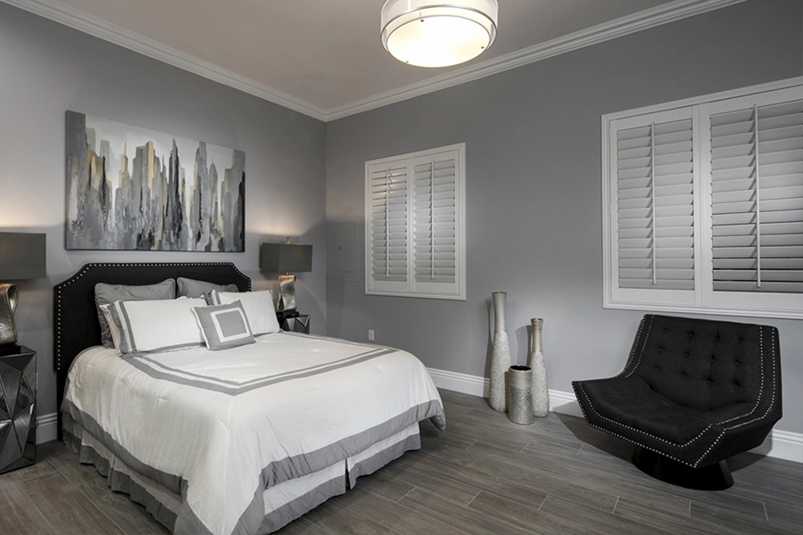 Close your custom Polywood shutters to beat the heat and keep your Salt Lake City bedroom cool. White Polywood shutters on bedroom windows